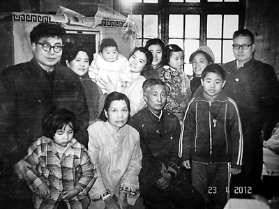 1970年代，隆学义（左一）和前妻鲜述文（左二）及儿子隆准（右二）在解放东路家中和亲友合影。图/隆学义、鲜述文、马拉